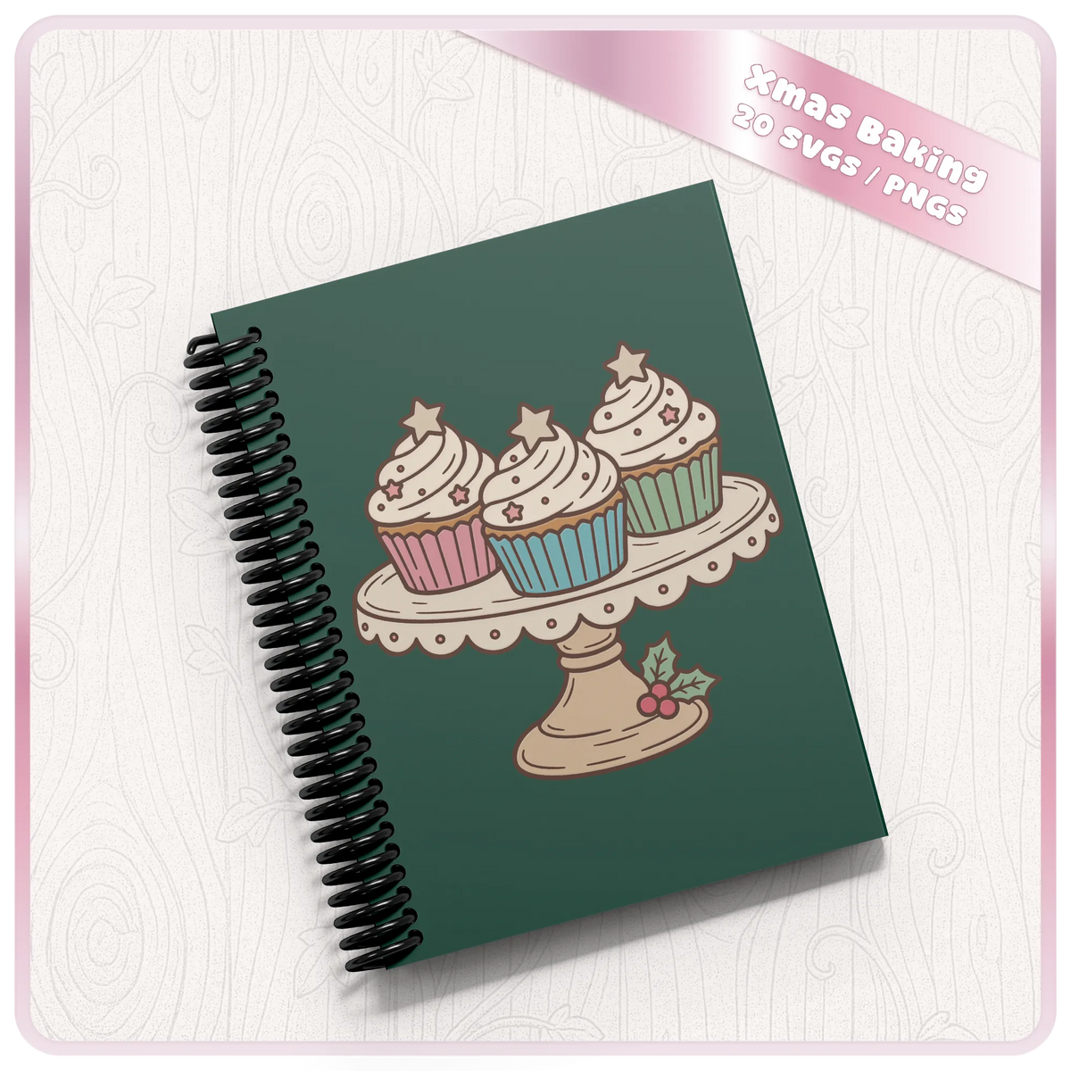 Christmas cupcake stand SVG and PNG clipart displayed on a dark green spiral notebook, showing a festive baking design for craft projects.
