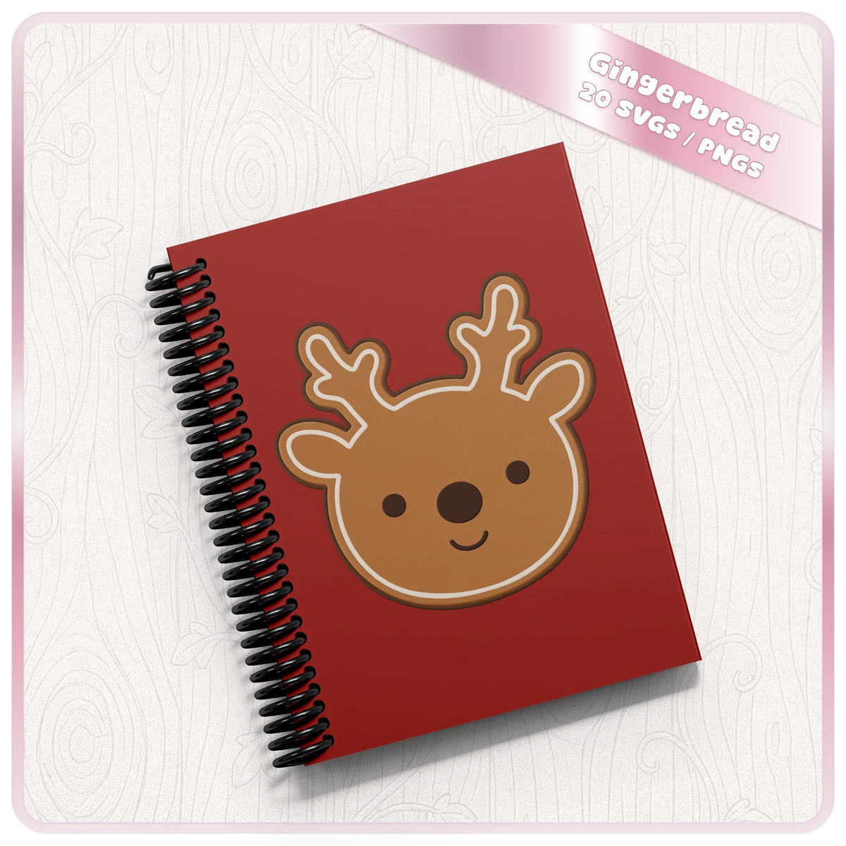 Cute gingerbread reindeer PNG clipart design displayed on a red spiral notebook, showing a Christmas craft idea using the festive digital bundle.