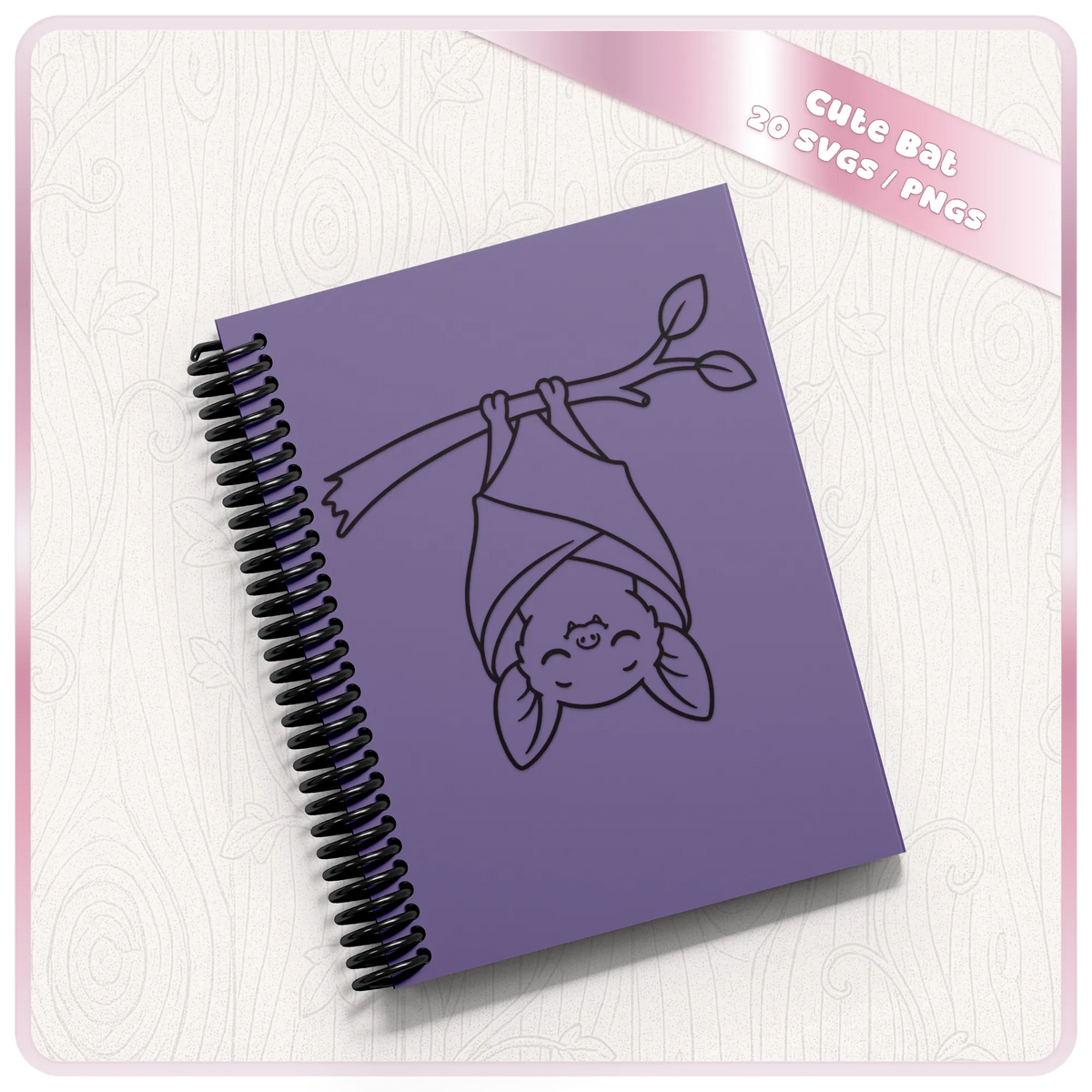 Cute hanging bat SVG displayed on purple spiral notebook mockup showing adorable bat clipart for stationery, gifts and Halloween crafts.