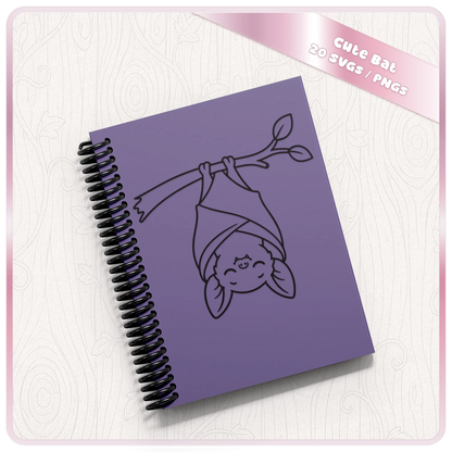 Cute hanging bat SVG displayed on purple spiral notebook mockup showing adorable bat clipart for stationery, gifts and Halloween crafts.
