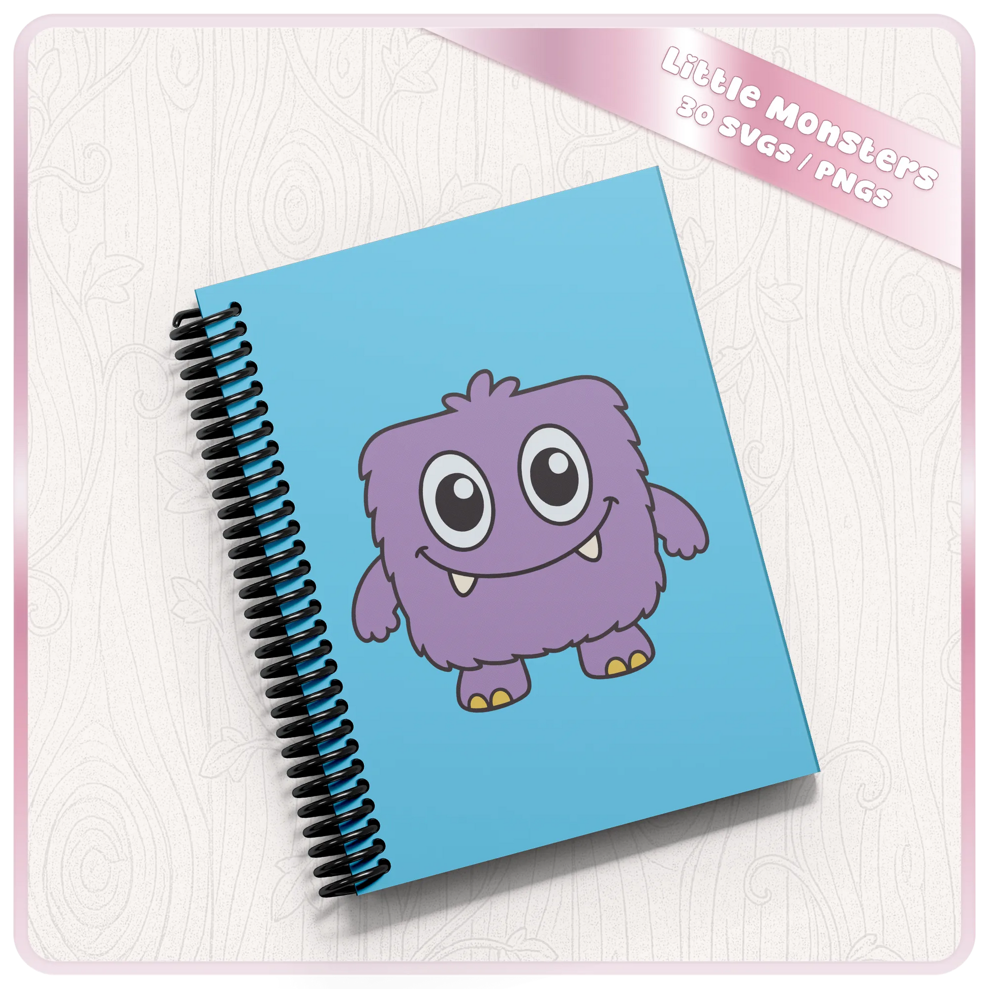 Notebook mockup featuring a purple cute monster illustration from the Little Monsters SVG and PNG bundle for printable and sublimation crafts.