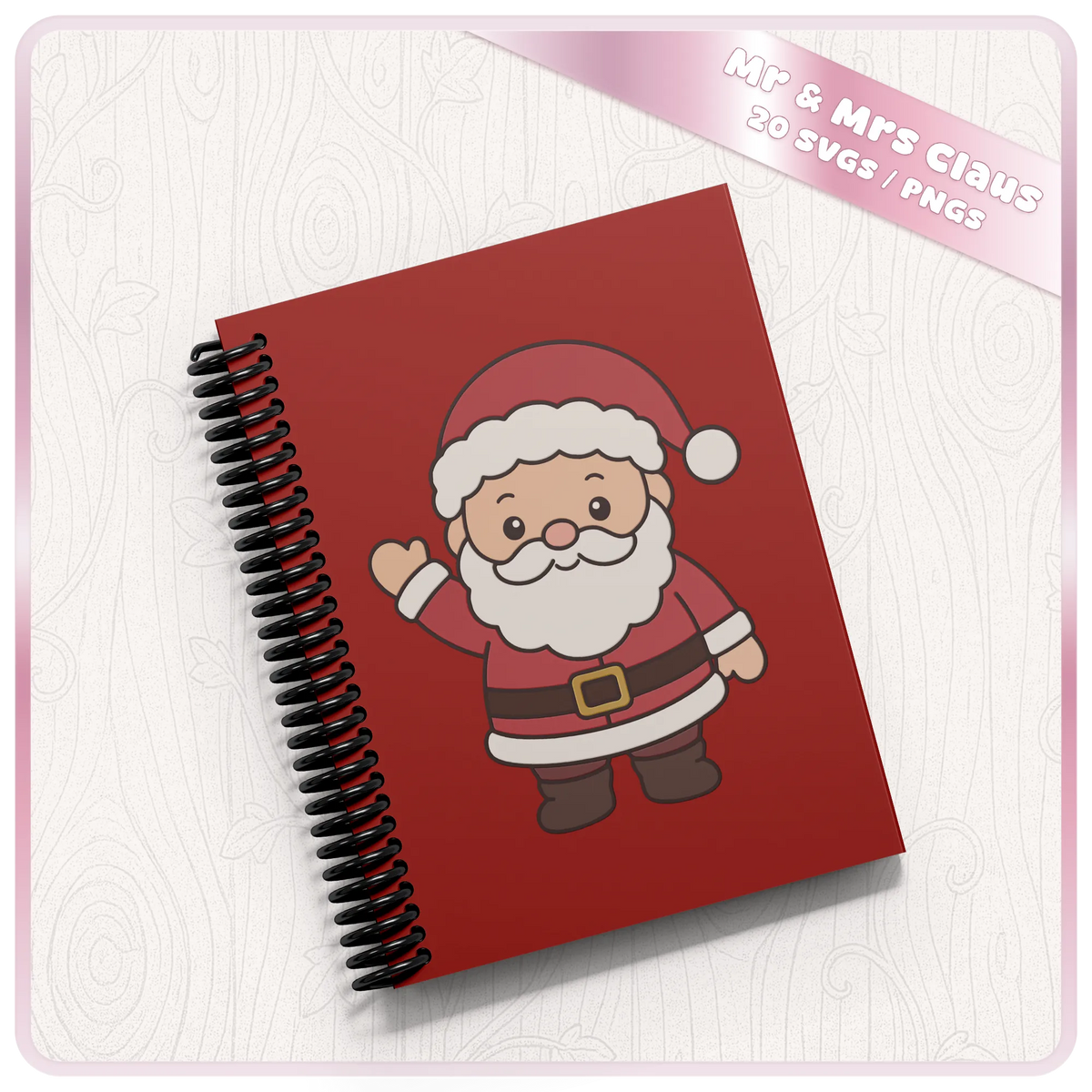Cute waving Santa Claus Christmas PNG clipart design displayed on a red spiral notebook, showing a festive craft project idea.