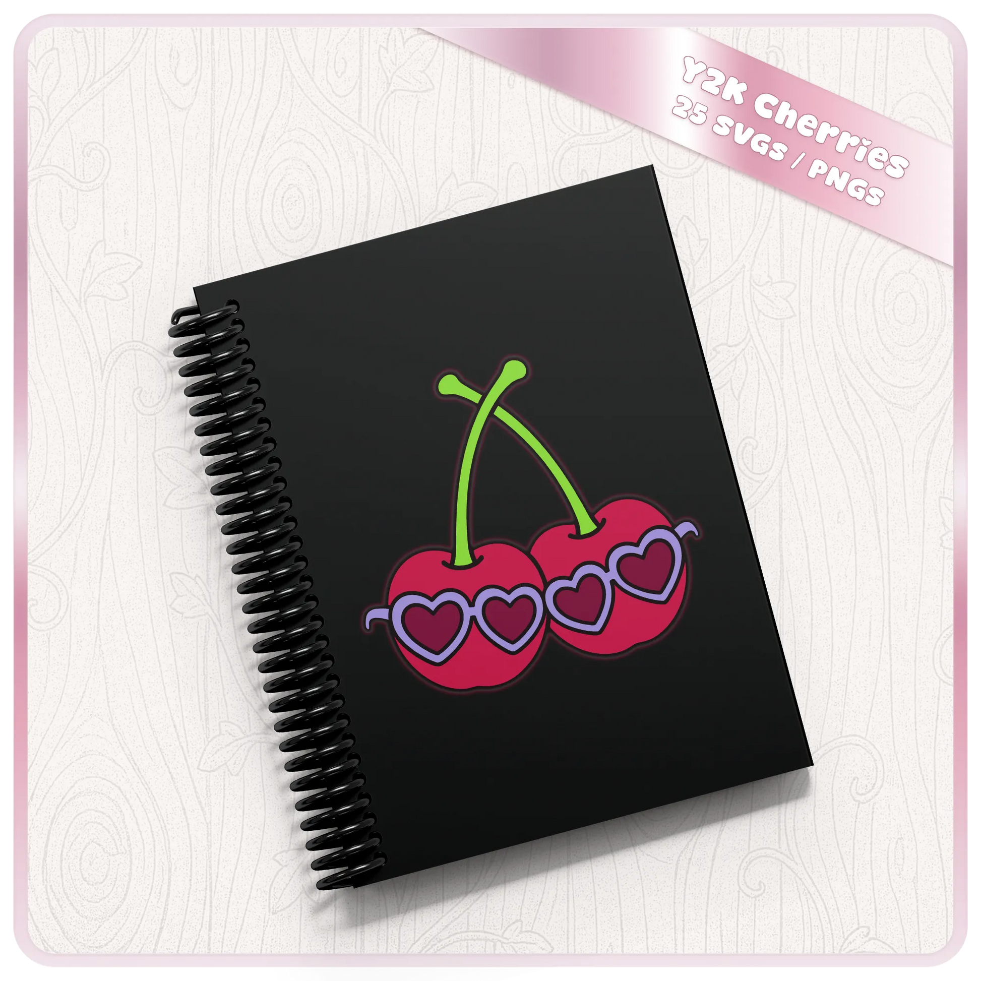 Black spiral notebook mockup decorated with retro cherries wearing purple heart-shaped sunglasses.