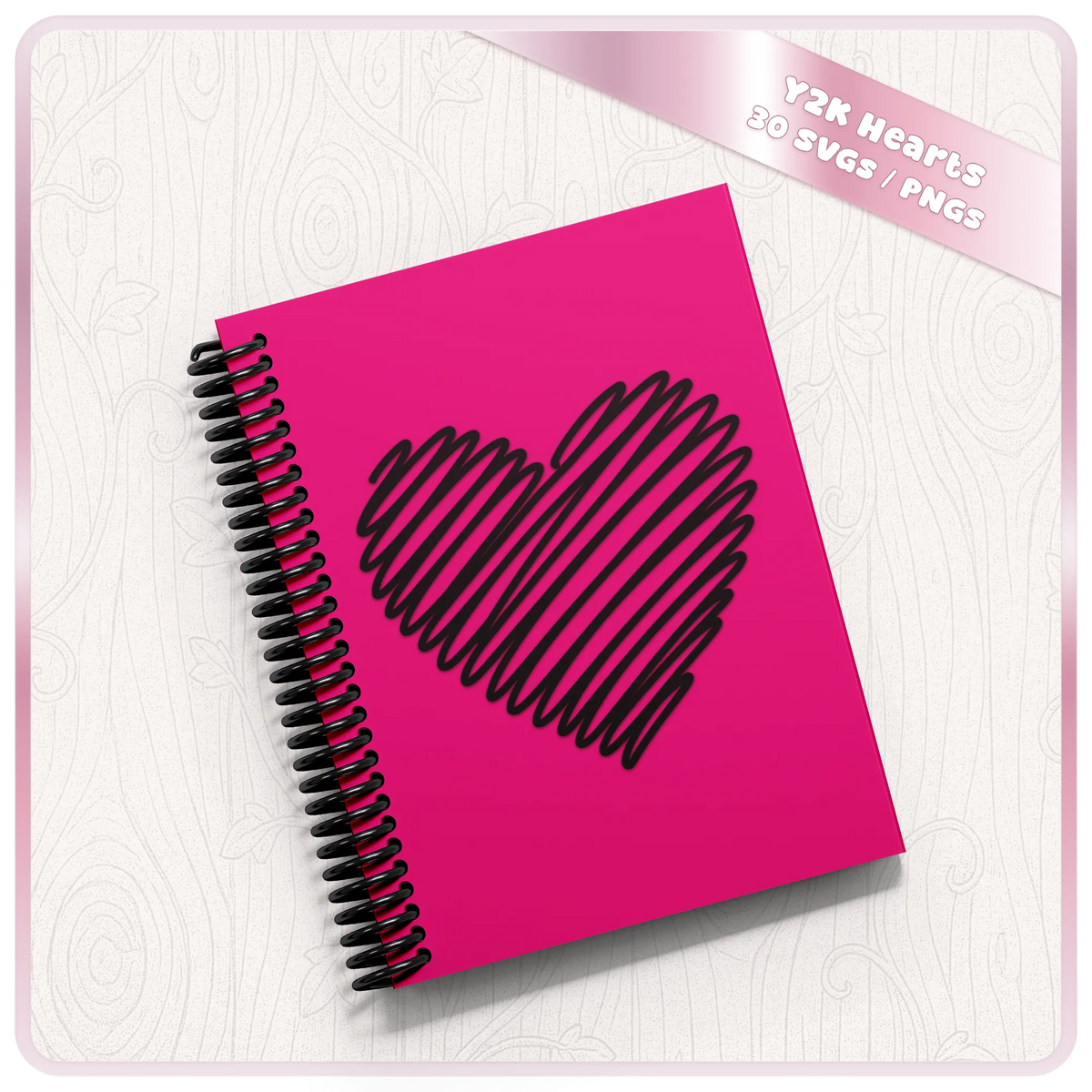 Scribble doodle heart SVG design shown on a pink spiral notebook, from the 30 hand drawn hearts SVG and PNG clipart bundle